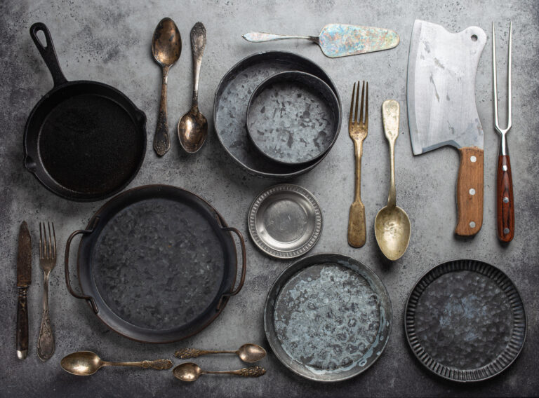 Old vintage tableware and kitchen utensils on rustic stone backg